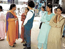 Girls wait outside a college after taking the B.Ed examination in Ludhiana on Sunday.
