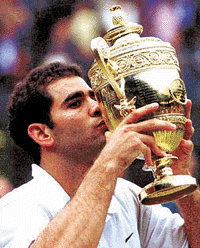 Pete Sampras kisses the trophy, after defeating Australia's Patrick Rafter in the Men's Singles final on the Centre Court at Wimbledon, on  Sunday
