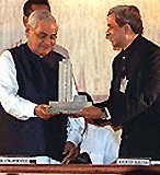 Prime Minister Atal Behari Vajpayee being presented a glass memento of the stock exchange by Anand Rathi president of the BSE, in Mumbai on Sunday. �  PTI photo