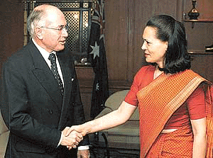 Australian Prime Minister John Howard (L) shakes hands with Mrs Sonia Gandhi, leader of the Congress, in New Delhi on Tuesday