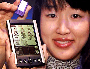Ayako Kojima, an employee of Japan's electronics giant Sony, displays the new Palm OS based personal digital assistant (PDA) at the company's showroom in Tokyo 13 July 2000.  The "Personal Entertainment PEG-S500C", is equipped with a color LCD, a memory stick IC slot, and allows connection via mobile phone. Sony will put it on the domestic market in September at an estimated price of 60,000 yen (555 USD).     AFP photo