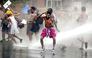 Demonstrating Indian Railway technicians wearing only their underwear, are doused by a water canon as they try to march towards Parliament in New Delhi on Thursday. The workers were demonstrating for better wages, claiming their current wage was not enough to buy clothes