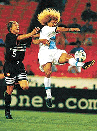 Tampa Bay Mutiny's Carlos Valderrama, right, kicks the ball past D.C. United's Geoff Aunger, left, during the second half on Wednesday, at RFK Stadium in Washington. The game ended in a 2-2 tie.