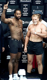 Britain's heavyweight World champion Lennox Lewis, and his challenger South Africa's Fancois Botha, (right) react to the crowds during their open-air weigh-in at London's Covent Garden, on Thursday