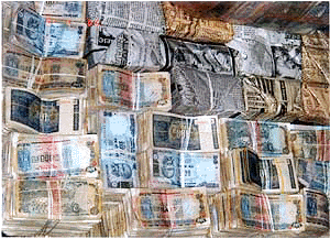 Several bundles of currency notes  amounting to Rs 2.40 crores were seized by the income tax sleuths after raiding residence of a middle class businessman in Mumbai