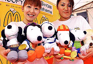 Japan McDonald's campaign girls, Ayako Kubota (L) and Naomi Kondo, display various kinds of Snoopy stuffed dolls, priced at 380 yen ($ 3.6 ) a piece, during the McDonald's sales campaign in Yokohama, suburban Tokyo, on Saturday. Japan's McDonald's chain will start a new campaign with Snoopy characters from July 20. � AFP photo