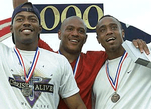 Sprinters Maurice Greene (C), Curtis Johnson (L) and Jon Drummond(R) celebrate on the podium.