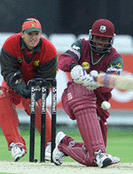 West Indies batsman Brian Lara plays a sweep shot.