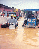 An incessant rain over the past 24 hours has left behind a trail of destruction. However, some persons do not mind wading happily through waist-deep rain water, unmindful of the danger it might pose. 