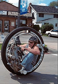 Kerry McLean, designer and builder of this unique one-wheeled motorcycle, cruises through Walled Lake (USA) on Wednesday. A seat inside the 4-feet tall tire, faces a 40-horsepower, water-cooled snowmobile engine. A rider, curled in the foetal position, can reach speeds up to 100 mph, says McLean. � AP photo
