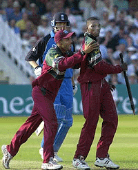 West Indies bowler Chris Gayle (right) is congrartulated by team captain Jimmy Adams after taking three England wickets in the last over to win the one day international at Trent Bridge Nottingham, on  Thursday