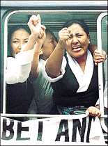Tibetans, living in exile in India, shout anti-Chinese slogans after being detained by Indian police for protesting against the visit of Chinese Foreign Minister Tang Jiaxuan in New Delhi. Tang is in India on a two-day visit