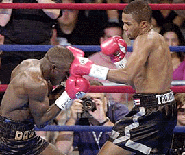 WBA champion Felix Trinidad of Puerto Rico, right, lands a jab to the head of Mamadou Thiam of France during the first round of the WBA super welterweight title fight at the American Airlines Arena, on Saturday