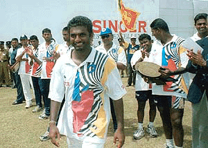 Sri Lankan bowler Muthiah Muralitharan smiles his teammates during the presentation of awards after Sri Lanka beat South Africa by an innings and 15 runs in the fourth day of the first cricket match in the Galle International cricket ground in Galle, Sri Lanka, on Sunday