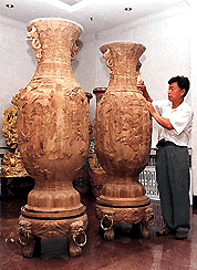 Two vases carved from wood are displayed in Mudanjiang city, in China's Heilongjiang province, on Saturday. The 6-feet tall vases each depict a scene from the Chinese literary work, "Dreams of the Red Mansion". � AP/PTI photo