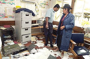 Fijian Parliamentary Secretary Mary Chapman, right, surveys on Tuesday,  the ransacked a parliamentary office where coup leader George Speight took dozens of lawmakers hostage for 56 days until their release on July 13. Speight rejected President Ratu Josefa Iloilo's Cabinet lineup for an interim government and warned of a renewed campaign of civil unrest by his supporters if the government is not stacked with his nominees