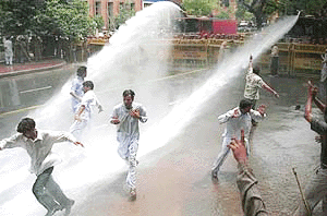Police using water canon to disperse the Indian Youth Congress demonstrators who were protesting against the price rise, unemployment and attack on minorities, in New Delhi on Tuesday