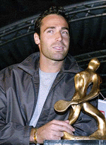 Spain's Alex Corretja holds the trophy after he was awarded most popular tennis player by journalists during the "Players Night" in Kitzbuehel on Tuesday
