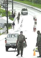 Following the arrest of Fijian coup leader George Speight overnight, Fijian troops man a roadblock on Thusday, when their comrades raid on Speight's supporters' camp at a Kalabu local school in Suva. A supporter of Speight died, 30 others were injured and hundreds were arrested in the troops storm
