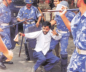 Policemen beat up an activist from Trinamool Congress who tried to enter the main secretariat building in Calcutta on Friday. More than 50 activists from Trinamool Congress staged a protest outside the secretariat against the killing of 11 persons on Thursday