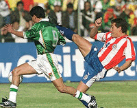 Defender Carlos Gamarra (R) of the Paraguay national soccer team battles for the ball with Joaquin Botero of Bolivia during their sixth qualifying match for the 2002 World Cup, in the Hernando Siles Stadium in La Paz, on Thursday. � Reuters