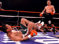 Julio Cesar Chavez falls to the mat after losing his balance as Kostya Tszyu watches during the fifth round of their WBC super lightweight title fight on Saturday in Phoenix