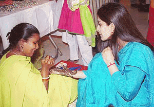 A young visitor getting a mehandi treat at the Teej festival being held in New Delhi on Saturday