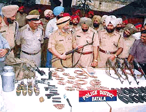 Police personnel inspecting arms and ammunition seized from Indo-Pakistan border at Dera Baba Nanak sector in Punjab on Sunday