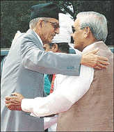 Indian Prime Minister Atal Behari Vajpayee (R) hugs his Nepali counterpart Girija Prasad Koirala upon arrival in New Delhi on Tuesday. Koirala, first Nepali Prime Minister to visit India in four years, is in India on a five-day official visit to discuss security concerns
