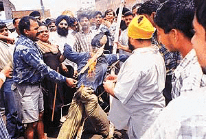 Shopkeepers of Circular Road burn an effigy of Pakistan�s military ruler Gen Parvez Musharraf in Ludhiana on Wednesday to protest against the killings of pilgrims of the Amarnath yatra.
