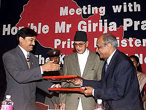 CII President Arun Bharat Ram exchanges the documents with his Nepalese counterpart Pradeep K. Shrestha after signing an MoU between CII and FNCCI in the presence of Nepalese Prime Minister G.P. Koirala in New Delhi on Wednesday. � PTI photo
