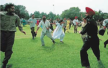 Punwire employees being lathi-charged at the CHB roundabout in Chandigarh on Wednesday.� Tribune photo by Pradeep Tewari