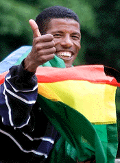 Ethiopian 10,000-meter star Haile Gebrselassie wears his country's flag, at the Ethiopian embassy in London, on Wednesday