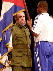 Cuban President Fidel Castro, hands over a flag to Olympic boxing champion Felix Savon during a ceremony for the Olympic team participating at the games in Sydney in September, on  Wednesday in Havana, Cuba