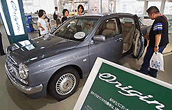 Customers inspect a limited-edition sedan �Origin� from Toyota Motor Corporation at its showroom in Tokyo on Thursday. Toyota will offer only 1,000 models with a 3-litre-engine in commemoration of achieving 100 million in domestic production. � AFP photo