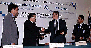 Microsoft founder Bill Gates, centre right, shakes hands with Philippine President Joseph Ejercito Estrada at the Microsoft Executive Briefing Center in Redmond, Wash., on  Wednesday. Microsoft signed a joint initiative memorandum agreement to donate $12 million of software to schools in the Philippines. �  AP/PTI photo