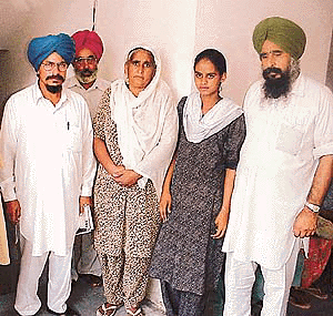 Mr Tarsem Jodhan (second from left) with the parents of the youths who died after taking Celphos tablets in Khera village, at a press conference in Ludhiana on Saturday. � Photo by Rajesh Bhambi