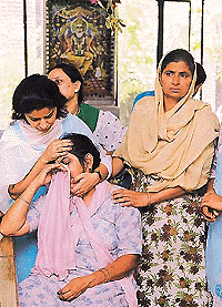 Widow of Harjinder Singh being consoled by relatives � Tribune photo by Pradeep Tewari