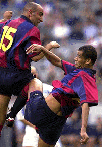 Barcelona players Abelardo, left, and Rivaldo collide as they both react to a high ball during the match Lazio Roma of the Amsterdam Tournament at the ArenA stadium in Amsterdam on Saturday