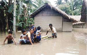 People moving to a safer place from the flood-affected Guwahati city on Saturday. Downpours have caused flashfloods killing 59 persons and leaving about 2.5 million homeless in Assam and Bihar