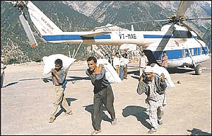 HP Food and Civil Supplies Corporation staff carry essential commodities to the flood affected areas of Rampur, Kulu and Kinnaur through helicopters