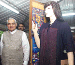 Prime Minister A.B. Vajpayee standing in front of mannequin wearing dresses made by the members of the 'SEWA' (Self Employed Women Association) at his residence in New Delhi on Monday