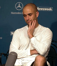 Andre Agassi listens to questions during a news conference, on Wednesday,  in Mason, Ohio, after he withdrew from his second round match at the Tennis Masters Series Cincinnati tournament with a recurring back injury