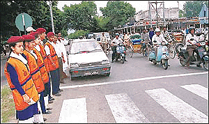 Schoolchildren, who are members of the National Social Service (NSS), manning traffic in Sector 22 in Chandigarh on Thursday.					   � Tribune photo by Manoj Mahajan
