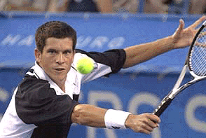 Number 15 seed Tim Henman, from Great Britain, returns a shot from opponent Pete Sampras during their third round match at the Tennis Masters Series-Cincinnati on Thursday night,  in Mason, Ohio