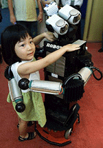 Playful prototype robot Robovie says "I love you" as it hugs four-year-old Hitomi Tachimura at Pre-Robo Festa Kansai 2001 in Osaka, western Japan on Friday