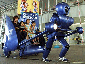A sneaker-clad robot rickshaw pulls children for a ride at Pre-RoboFesta Kansai 2001 in Osaka, western Japan on Friday