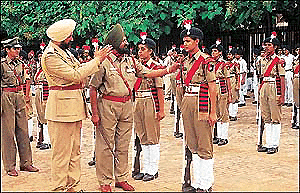A police official explains a point to a woman constable at the full dress rehearsal in Chandigarh Parade Ground in Sector 17 on Saturday. � A Tribune photo