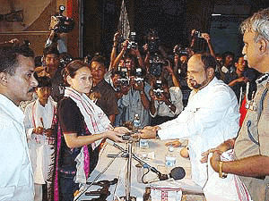 M.S. Betris Millikpih Sargent Major of United Peoples for Democratic Solidarity handing over her personal weapon to Assam Chief Minister P.K. Mohanta at a function in Guwahati on Monday before the Chief Minister including ULFA top leader Lohit Deuri with 53 weapons and atleast 88 kgs of explosives
