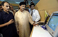 Indian Minister for Information Technology  Pramod Mahajan tries out a computer during the inauguration of the Centre for E-governance in New Delhi on Tuesday. The centre is a showcase of various initiatives by India's IT ministry to ease dialogue through the Internet between government departments and the citizens. It also aims to improve performance within government departments through various Intranet networks. On his left is Arun Shourie, minister of administrative reforms and public grievances. � AFP photo